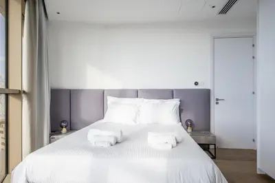 a bedroom with a white bed with towels on it at 360 Nicosia-3 bedrooms Panoramic Deluxe Residence in Nicosia