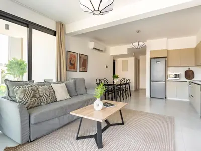 a living room with a couch and a table at Sanders Only in Limassol