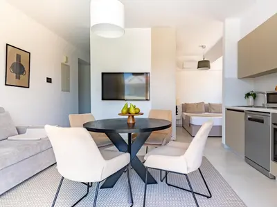 a kitchen and living room with a table and chairs at Sanders Only in Limassol