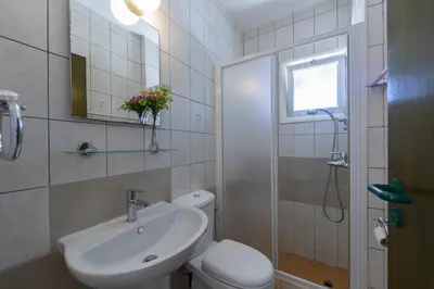 a bathroom with a sink and a toilet and a mirror at Melis Villa - Charming villa in Central Protaras in Protaras