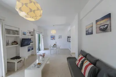 a living room with a couch and a table at Melis Villa - Charming villa in Central Protaras in Protaras