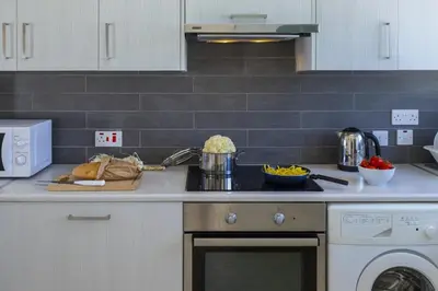 a kitchen with a sink and a stove top oven at Melis Villa - Charming villa in Central Protaras in Protaras