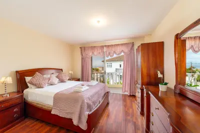 a bedroom with a bed and a large window at Protaras Posidon By The Sea in Protaras