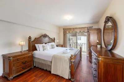 a bedroom with a bed with a mirror and a dresser at Protaras Posidon By The Sea in Protaras