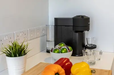a coffee maker and a bowl of vegetables on a counter at Platres Forty Pine Trees Cottage in Platres