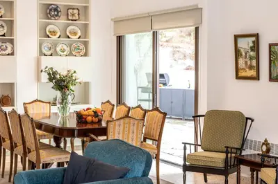 a dining room with a table and chairs at Platres Forty Pine Trees Cottage in Platres