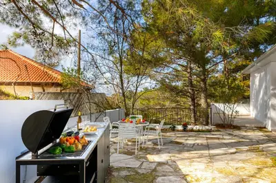 a backyard with a table with fruits and vegetables on it at Platres Forty Pine Trees Cottage in Platres
