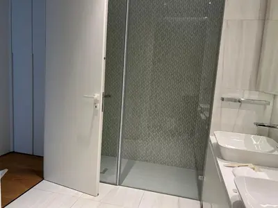 a bathroom with a glass shower and a sink at Del Mar Beachfront Boutique Residence in Limassol