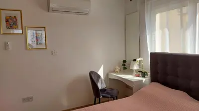 a bedroom with a bed and a desk and a chair at NISSI GOLDEN SANDS SEA VIEW 2 BEDROOM Apartment in Ayia Napa