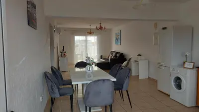 a kitchen and living room with a table and chairs at NISSI GOLDEN SANDS SEA VIEW 2 BEDROOM Apartment in Ayia Napa