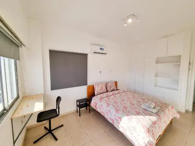 a bedroom with a bed and a chalkboard on the wall at City View Rooms in Larnaka