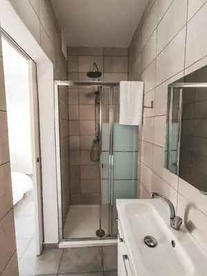 a bathroom with a shower and a sink at Shelter next to the beach in Larnaka