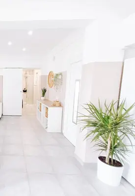 a white hallway with a potted plant at Shelter next to the beach in Larnaka