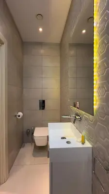 a bathroom with a sink and a toilet and a mirror at Vivo Mare Beachfront Villas - Seashell in Ayia Napa
