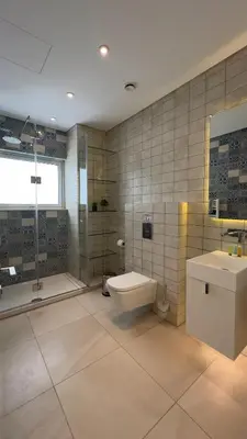 a bathroom with a toilet and a sink and a shower at Vivo Mare Beachfront Villas - Seashell in Ayia Napa