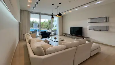 a living room with a white couch and a tv at Vivo Mare Beachfront Villas - Seashell in Ayia Napa