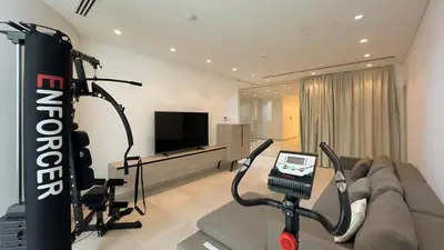 a living room with a couch and a gym at Vivo Mare Beachfront Villas - Seashell in Ayia Napa