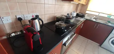 a kitchen with a counter with a coffee maker on it at Vasilas Holiday Apartment #2 in Larnaka