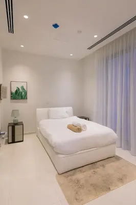 a white bedroom with a white bed and a window at Sea Pearl Beachfront Villas - Breeze in Ayia Napa