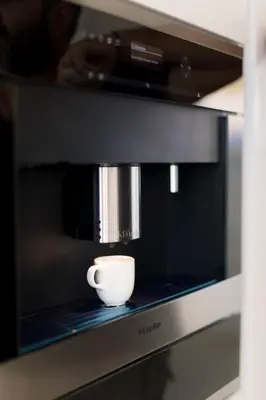 a coffee cup sitting on top of a microwave at Sea Pearl Beachfront Villas - Breeze in Ayia Napa