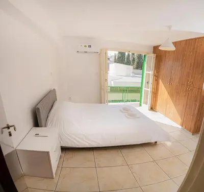 a bedroom with a white bed and a window at City center appartments in Nicosia