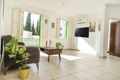 a living room with a tv and a couch and a table at City center appartments in Nicosia