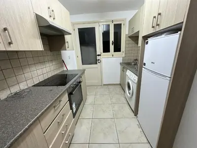 a kitchen with a white refrigerator and a dishwasher at City center appartments in Nicosia
