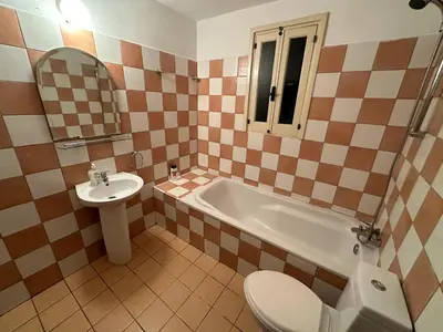 a bathroom with a sink and a tub and a toilet at City center appartments in Nicosia