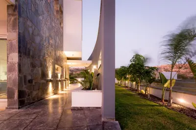 an exterior view of a building at night with plants at Sea Pearl Beachfront Villas - Anemone in Ayia Napa
