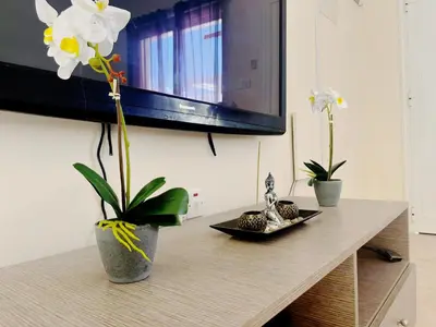 a table with two vases with flowers on it at Nissi Beach Golden Villas in Ayia Napa