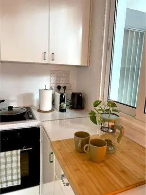 a kitchen with two cups on a wooden counter at Central Ground Floor Apartment in Nicosia