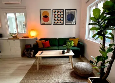 a living room with a green couch and a coffee table at Central Ground Floor Apartment in Nicosia