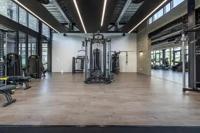 a gym with treadmills and machines in a room at Sunset Gardens in Limassol