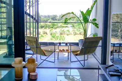 two chairs and a table in a room with a window at Sunset Gardens in Limassol