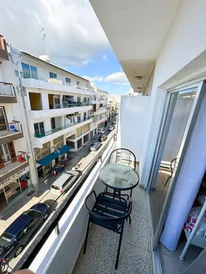 a balcony with a table and chairs and a street at Central Comfort Studio in Larnaka