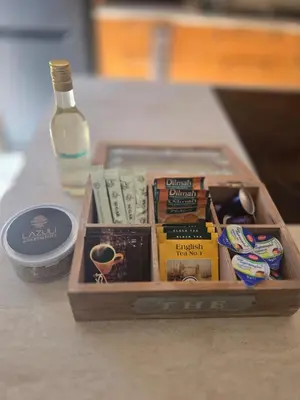 a wooden box with books and a bottle on a table at Lazuli Seafront Beach House Nr18 in Larnaka