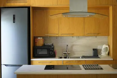 a kitchen with a sink and a refrigerator at Lazuli Seafront Beach House Nr18 in Larnaka