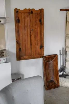 a wooden door on a wall in a kitchen at Omodos vintage houses in Omodos