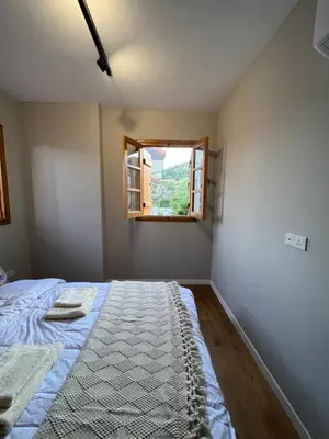 a bedroom with a bed and a window at Eftis - Renovated Traditional House in Omodos