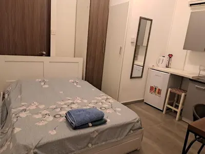 a bedroom with a bed with a gray blanket with flowers at Limassol Center Studios in Limassol