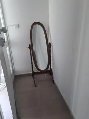 a mirror sitting on a stand in a hallway at Limassol Center Studios in Limassol
