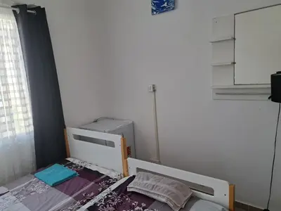 a small bedroom with a bed and a window at Limassol Center Studios in Limassol