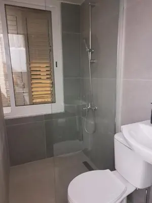 a bathroom with a toilet and a shower and a sink at Limassol Center Studios in Limassol