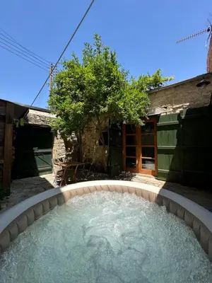 a pool of water in a backyard with at King's house in Lofou
