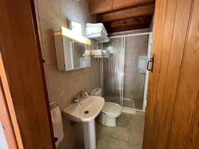 a small bathroom with a sink and a toilet at King's house in Lofou