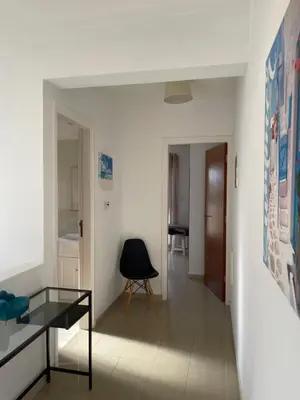 a living room with a glass table and a chair at Nissi Villa in Ayia Napa
