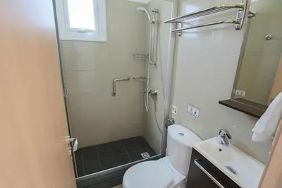 a bathroom with a shower and a toilet and a sink at Flouressia Gardens Villas in Protaras