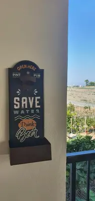 a sign on a wall that says save yourselves drink beer at STEFARIS PROPERTIES 'sioukris court' in Larnaka