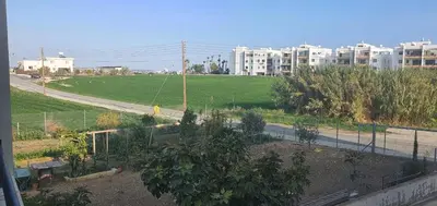 a view of a garden with a street and buildings at STEFARIS PROPERTIES 'sioukris court' in Larnaka
