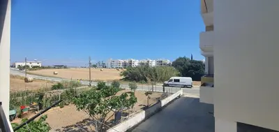 a view from a balcony of a street with a van at STEFARIS PROPERTIES 'sioukris court' in Larnaka